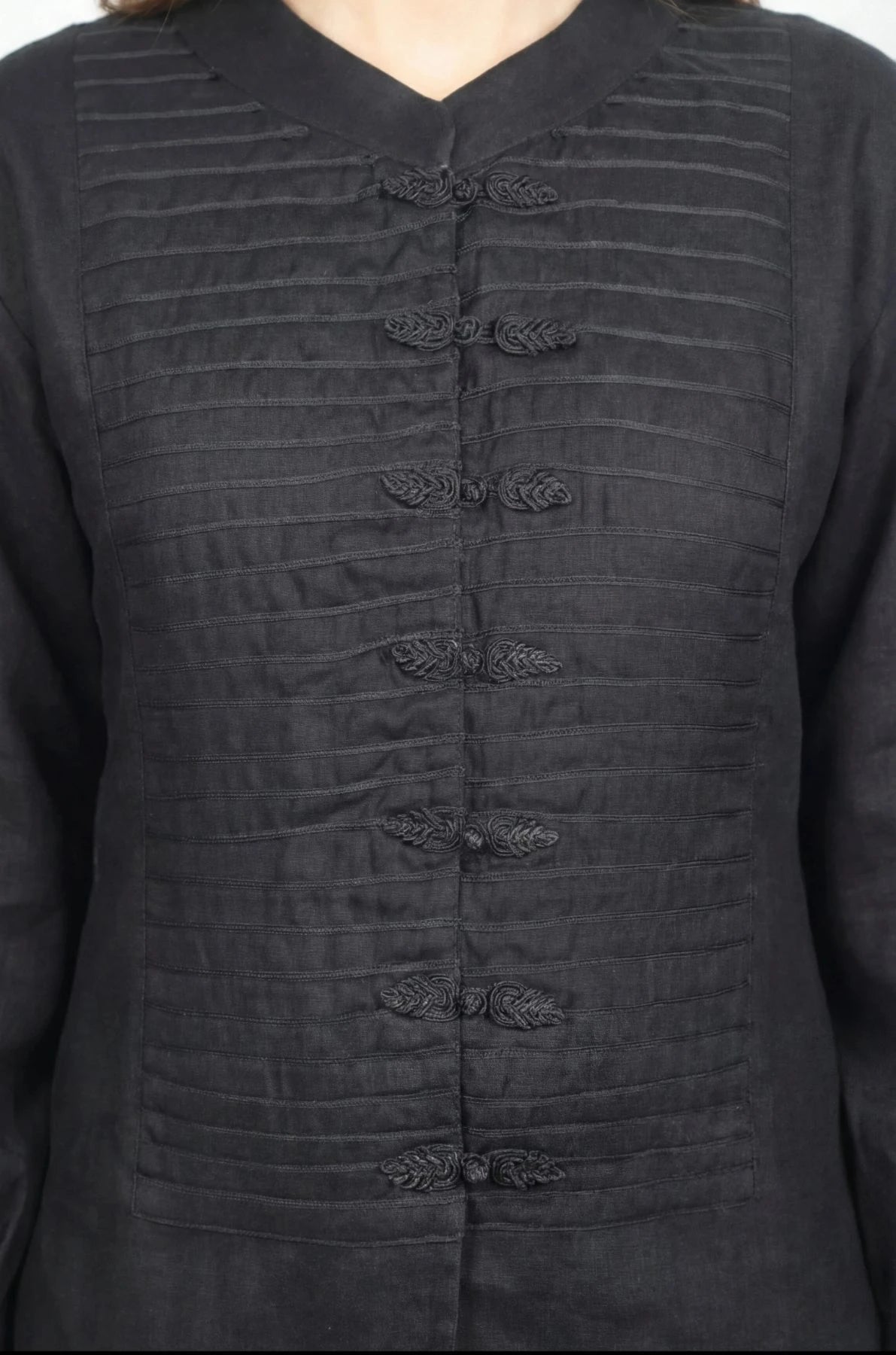 Inori Black Linen Top, black 100% linen mandarin collar blouse with frog-button knots, bell sleeves and adjustable corset-style lace-up back – flat lay detail