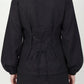 Inori Black Linen Top, black 100% linen mandarin collar blouse with frog-button knots, bell sleeves and adjustable corset-style lace-up back – styled on model