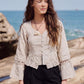 Rumi Top, handcrafted pure linen corset top with hand-braided sleeves, pleated ruffle hem and recycled floral appliques – styled on model