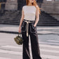Aether Linen Trouser, beige and black wide-leg pure linen trouser with hand-braided cotton rope belt and contrast piping – close-up detail