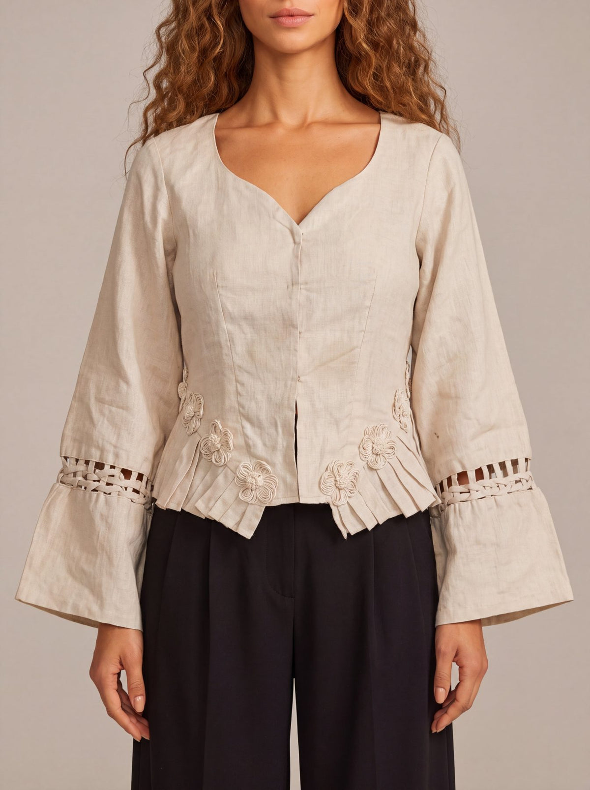 Rumi Top, handcrafted pure linen corset top with hand-braided sleeves, pleated ruffle hem and recycled floral appliques – back view