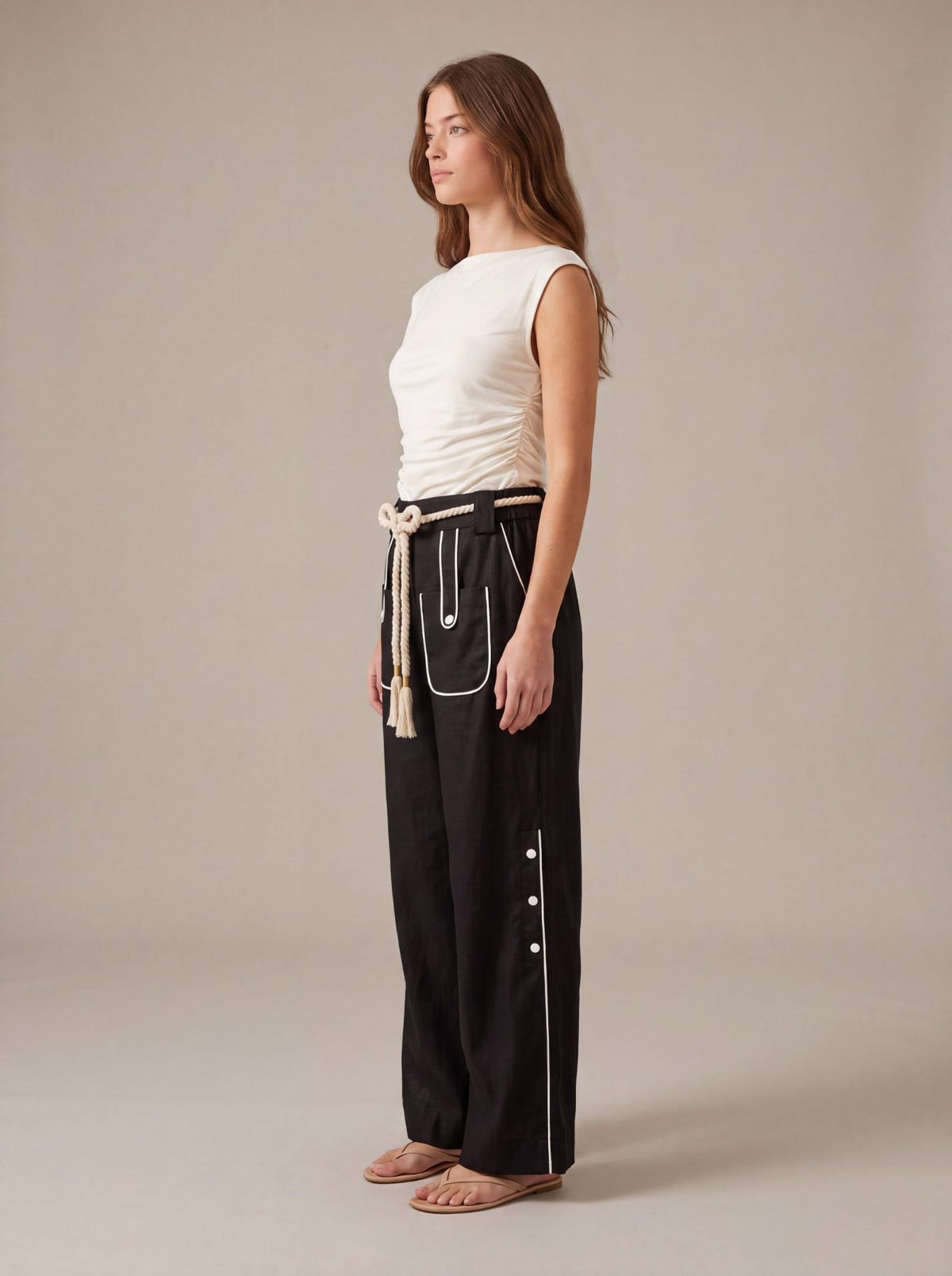 Aether Linen Trouser, beige and black wide-leg pure linen trouser with hand-braided cotton rope belt and contrast piping – flat lay detail