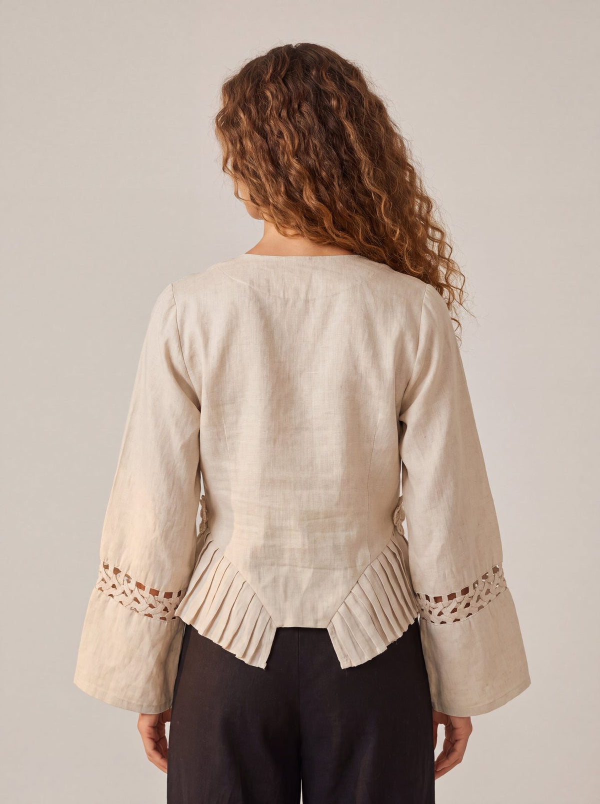 Rumi Top, handcrafted pure linen corset top with hand-braided sleeves, pleated ruffle hem and recycled floral appliques – alternate angle