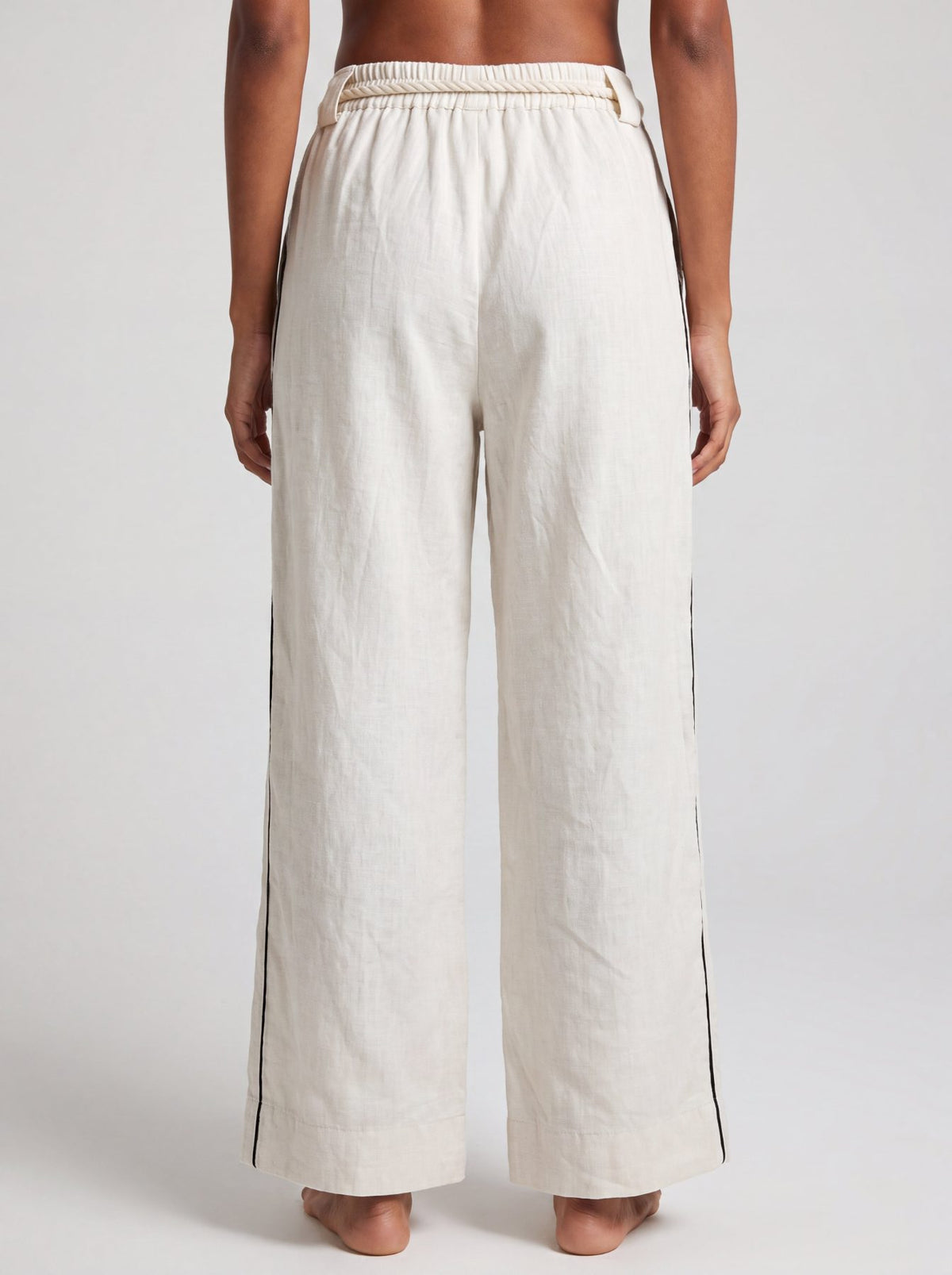 Aether Linen Trouser, beige and black wide-leg pure linen trouser with hand-braided cotton rope belt and contrast piping – close-up detail