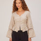 Rumi Top, handcrafted pure linen corset top with hand-braided sleeves, pleated ruffle hem and recycled floral appliques – flat lay detail