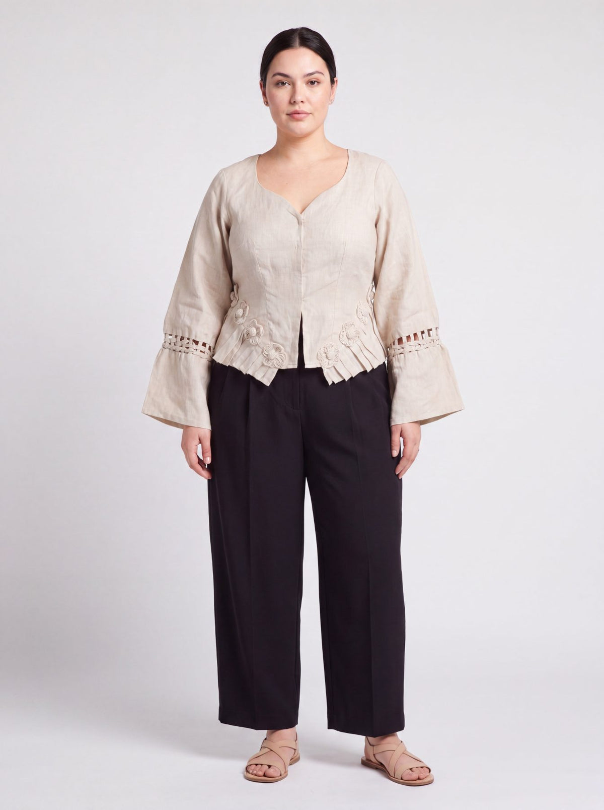 Rumi Top, handcrafted pure linen corset top with hand-braided sleeves, pleated ruffle hem and recycled floral appliques – front view