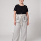 Aether Linen Trouser, beige and black wide-leg pure linen trouser with hand-braided cotton rope belt and contrast piping – front view