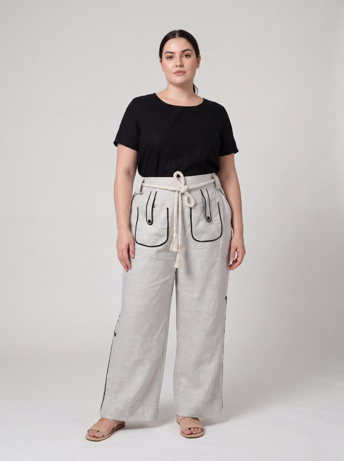 Aether Linen Trouser, beige and black wide-leg pure linen trouser with hand-braided cotton rope belt and contrast piping – front view