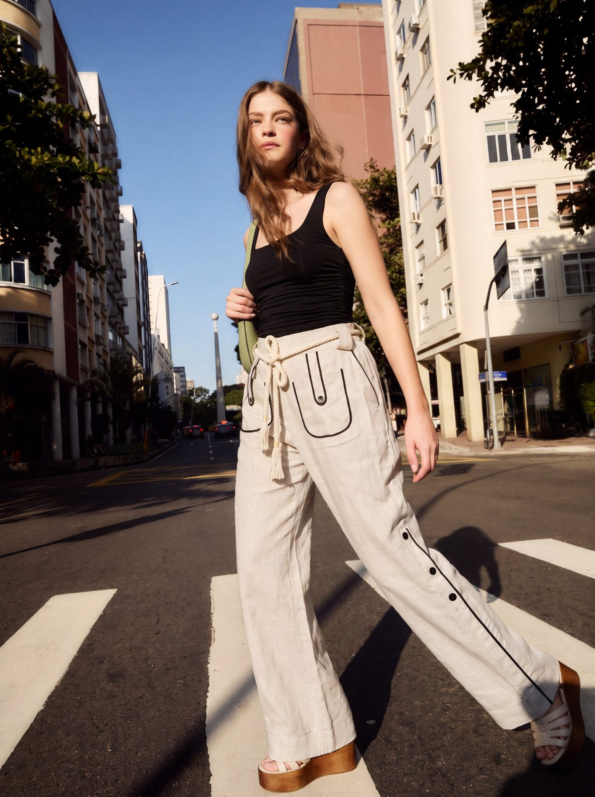 Aether Linen Trouser, beige and black wide-leg pure linen trouser with hand-braided cotton rope belt and contrast piping – styled on model